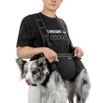 Pet owner carrying Border Collie with OneTigris SUPPORT RIDGE carry harness outdoors